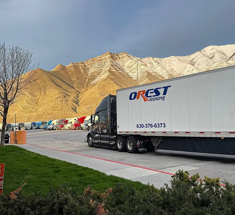 Orest Express tractor-trailer, unit 827, parked in front of mountains